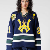 Front View Of A Female Model wearing The Navy, Yellow and Green Wisdom Of Age Knit Hockey Jersey.