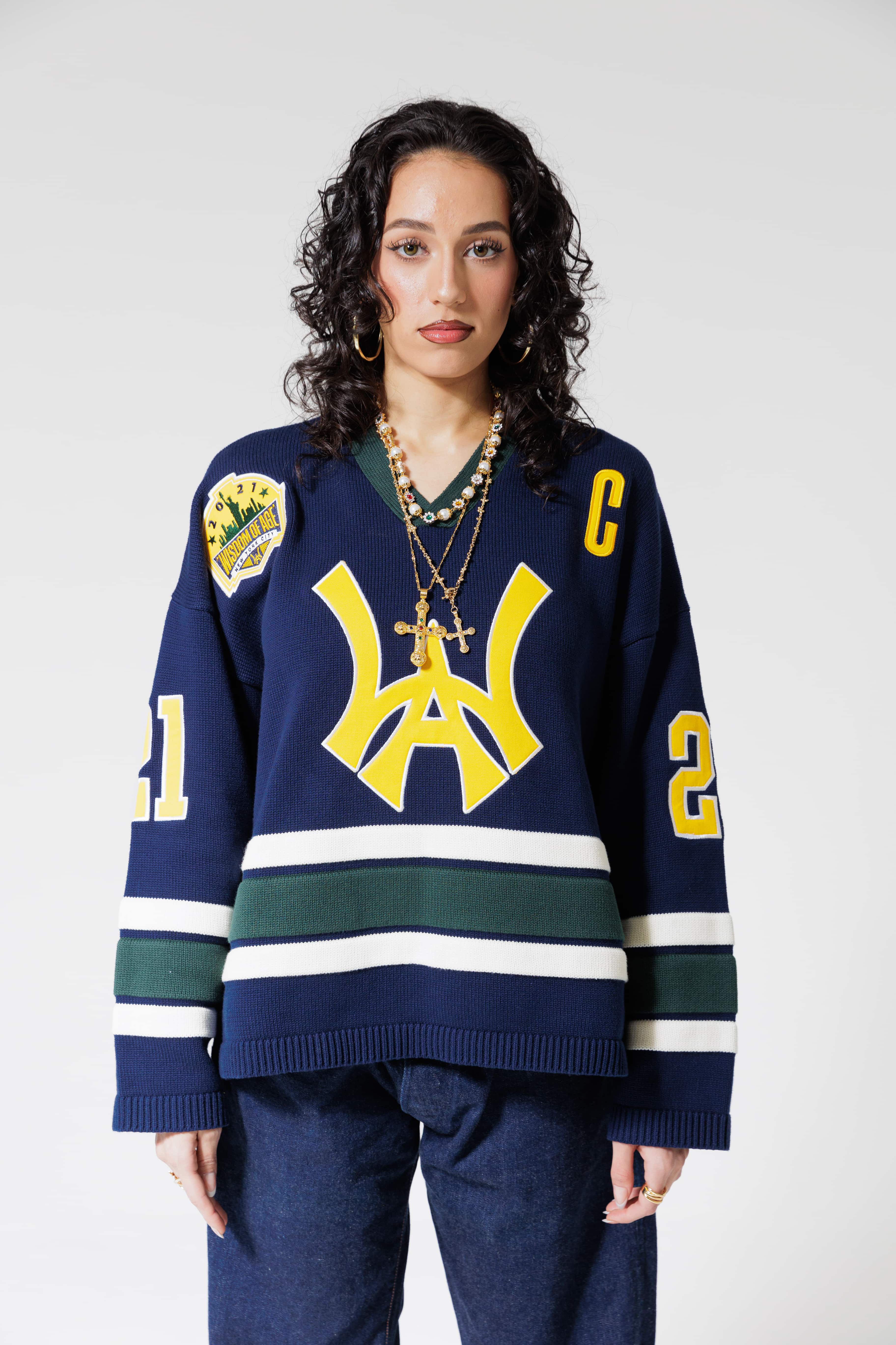 Front View Of A Female Model wearing The Navy, Yellow and Green Wisdom Of Age Knit Hockey Jersey.