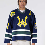 Front View Of A Male Model wearing The Navy, Yellow and Green Wisdom Of Age Knit Hockey Jersey.