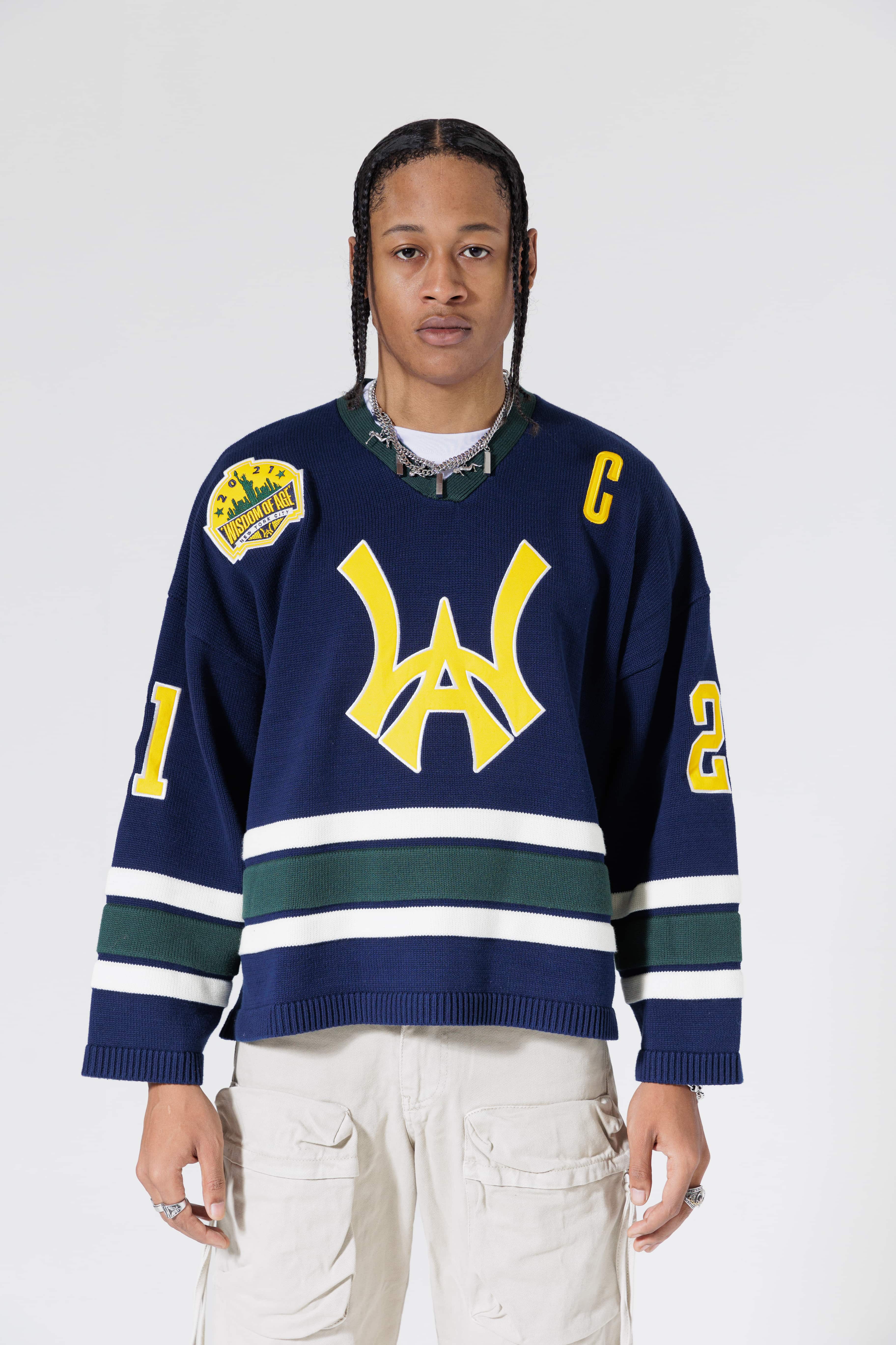 Front View Of A Male Model wearing The Navy, Yellow and Green Wisdom Of Age Knit Hockey Jersey.