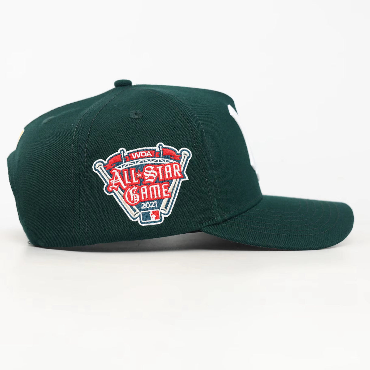 Green baseball cap with a WOA All-Star Game 2021 logo on a white background