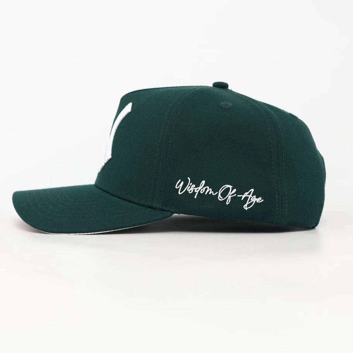 Green cap with 'Wisdom of Age' text on a white background