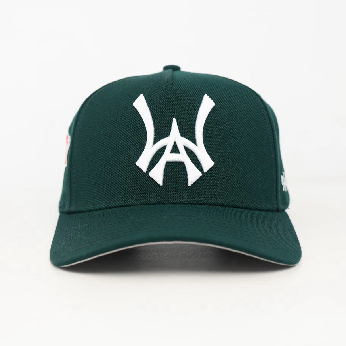 Green baseball cap with a white WA logo on a white background