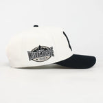 White and black cap with 'Wisdom of Face' logo on a white background