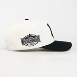 White and black cap with 'Wisdom of Face' logo on a white background