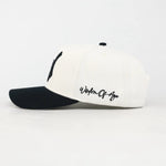 White and black cap with 'Wisdom of the Ages' text on a white background
