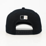 Black snapback cap with the WOA Liberty logo on the back against a white background