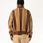 Rear view of a Male model wearing the WOA Knitted Brown and beige striped cardigan  on a white background.