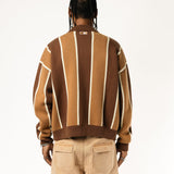 Rear view of a Male model wearing the WOA Knitted Brown and beige striped cardigan  on a white background.