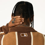 Close up rear view of a Male model wearing the WOA Knitted Brown and beige striped cardigan  on a white background.