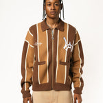 Male model wearing the WOA Knitted Brown and beige striped cardigan with WA logo on the left chest and 'Wisdom Of Age' written in script on the right chest on a white background.