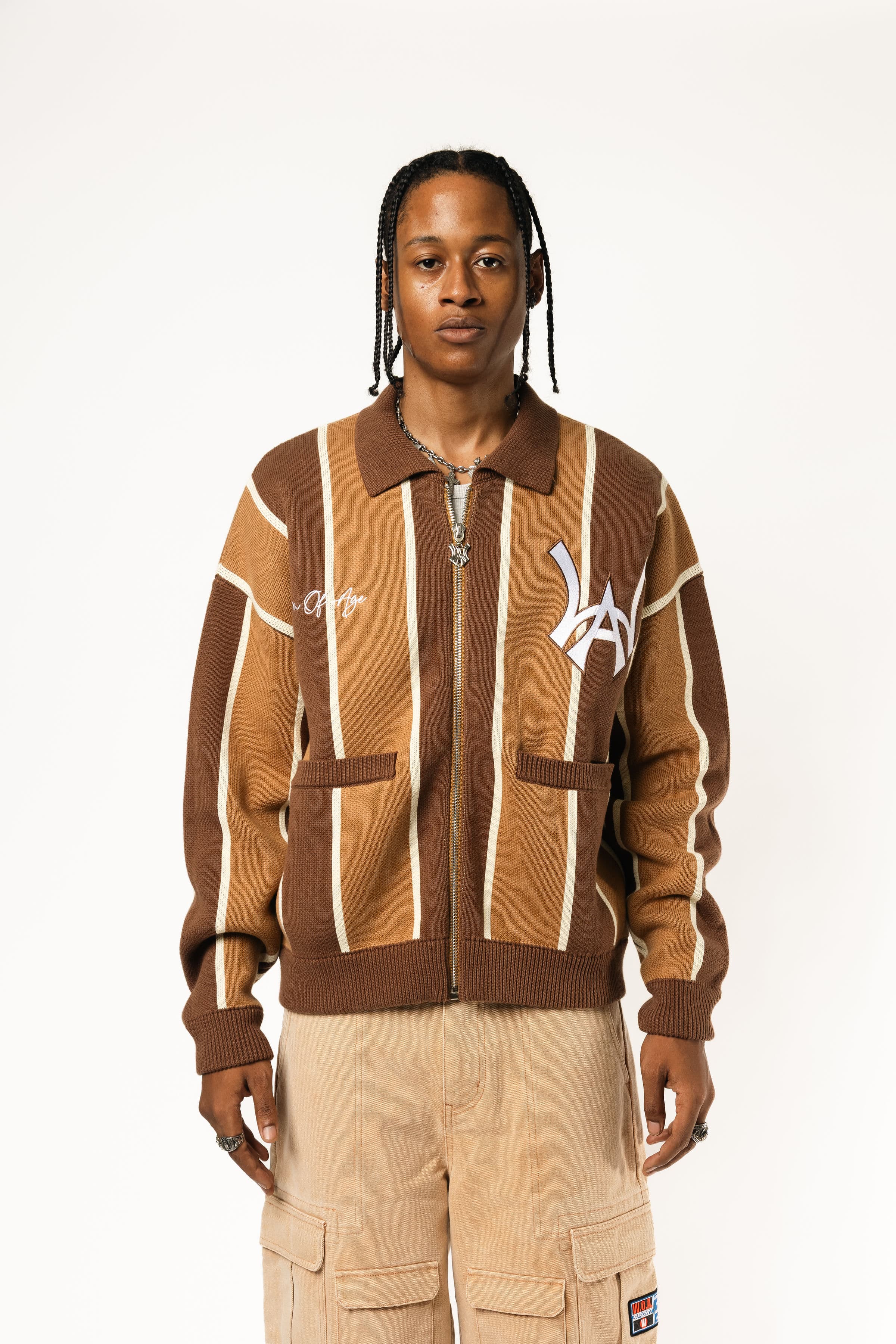 Male model wearing the WOA Knitted Brown and beige striped cardigan with WA logo on the left chest and 'Wisdom Of Age' written in script on the right chest on a white background.