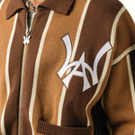 Close up of a Male model wearing the WOA Knitted Brown and beige striped cardigan with WA logo on the left chest and 'Wisdom Of Age' written in script on the right chest on a white background.
