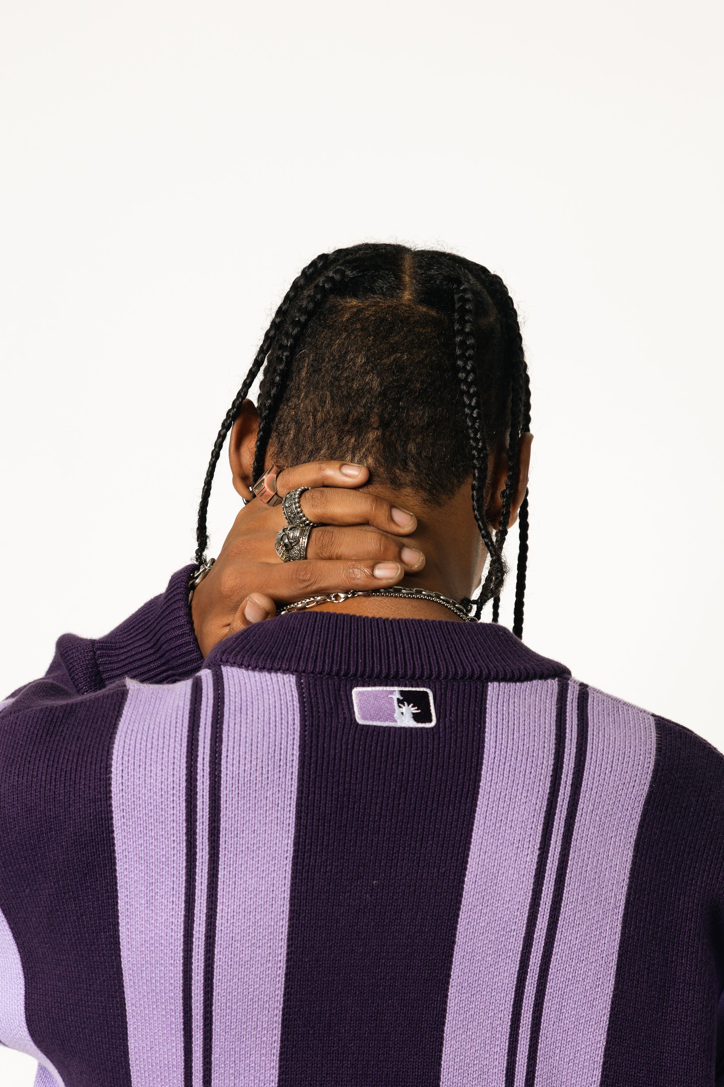 Close up rear View Of a Male Model wearing WOA Knitted purple cardigan on a white background.