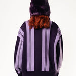 Rear View Of a female Model wearing WOA Knitted purple cardigan on a white background.