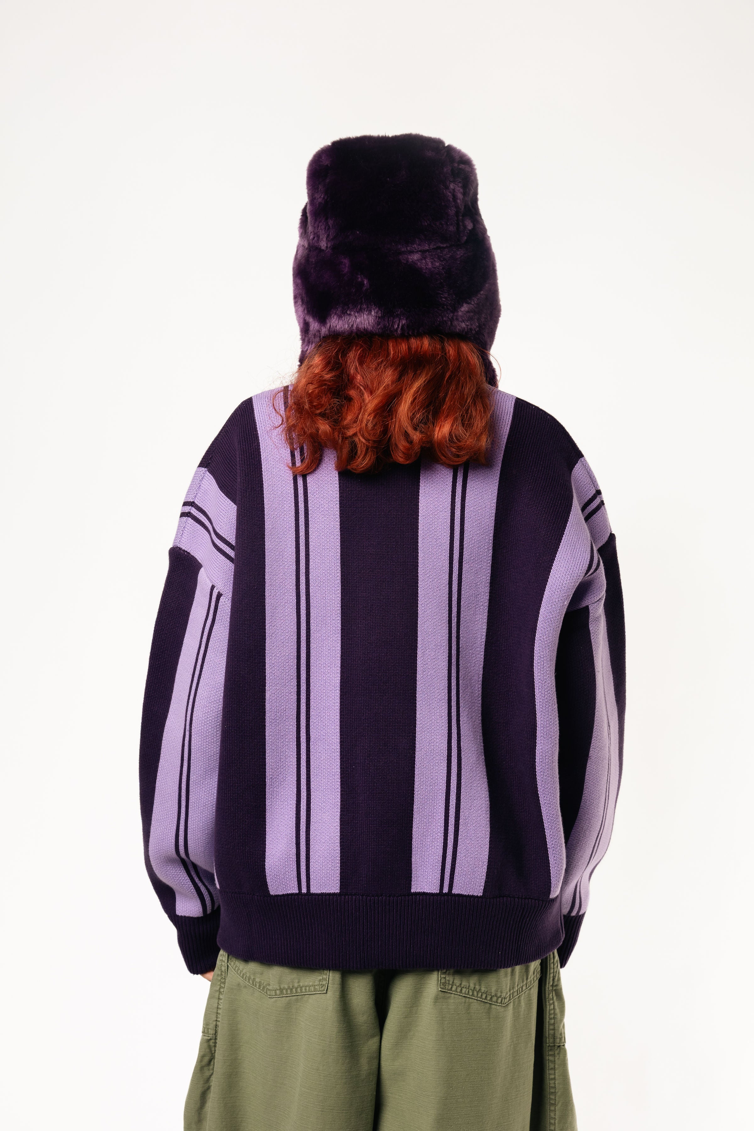 Rear View Of a female Model wearing WOA Knitted purple cardigan on a white background.