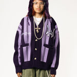 Front View Of a female Model wearing WOA Knitted purple cardigan on a white background.