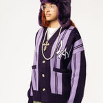 Front-side View Of a female Model wearing WOA Knitted purple cardigan on a white background.