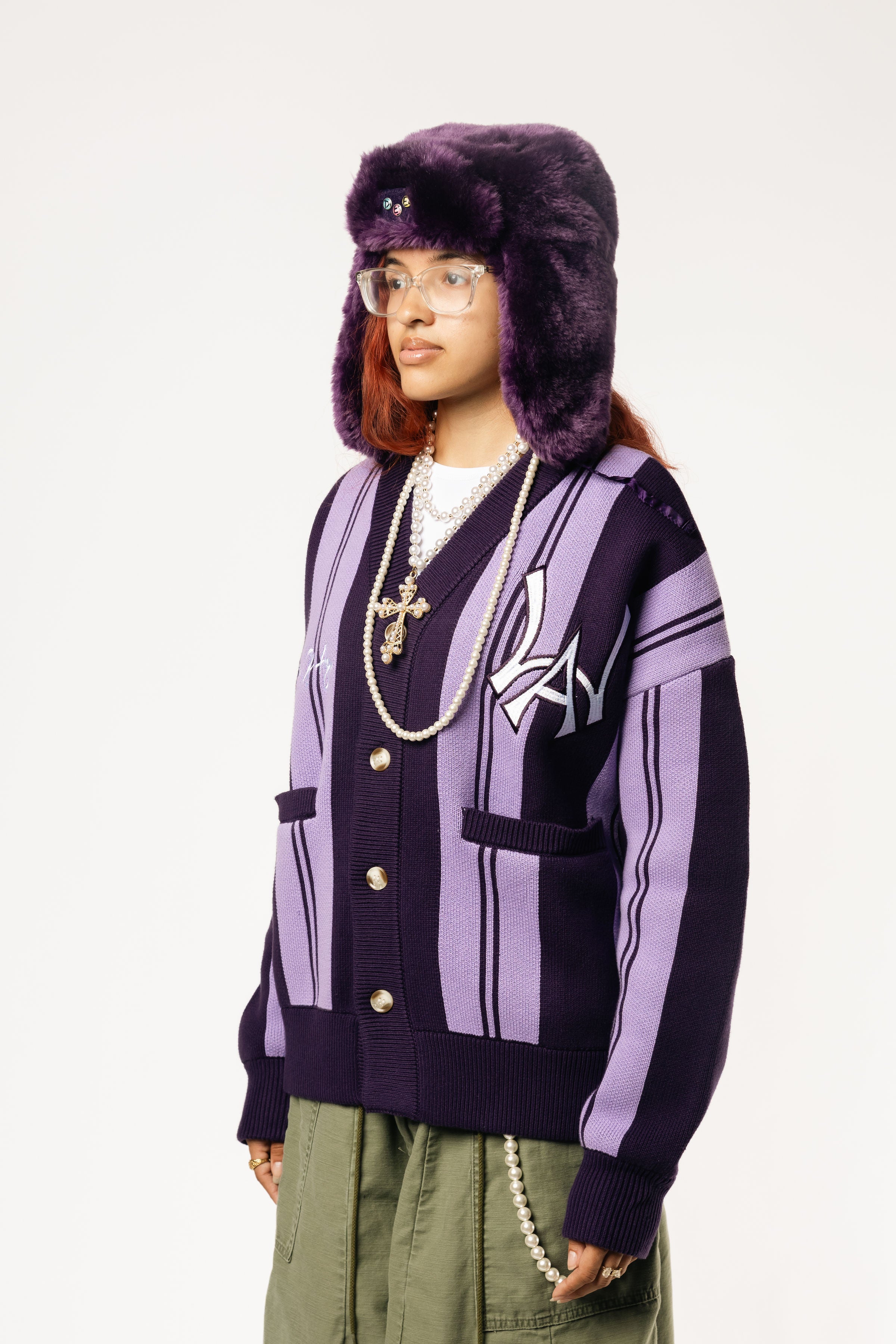 Front-side View Of a female Model wearing WOA Knitted purple cardigan on a white background.