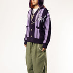 Full body Front View Of a female Model wearing WOA Knitted purple cardigan on a white background.