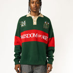 Male Model wearing a green and red, knitted rugby sweater with 'Wisdom of Age' text on a white background