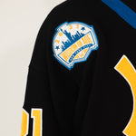 Close up of the Wisdom of Age liberty patch featuring the NYC skyline.