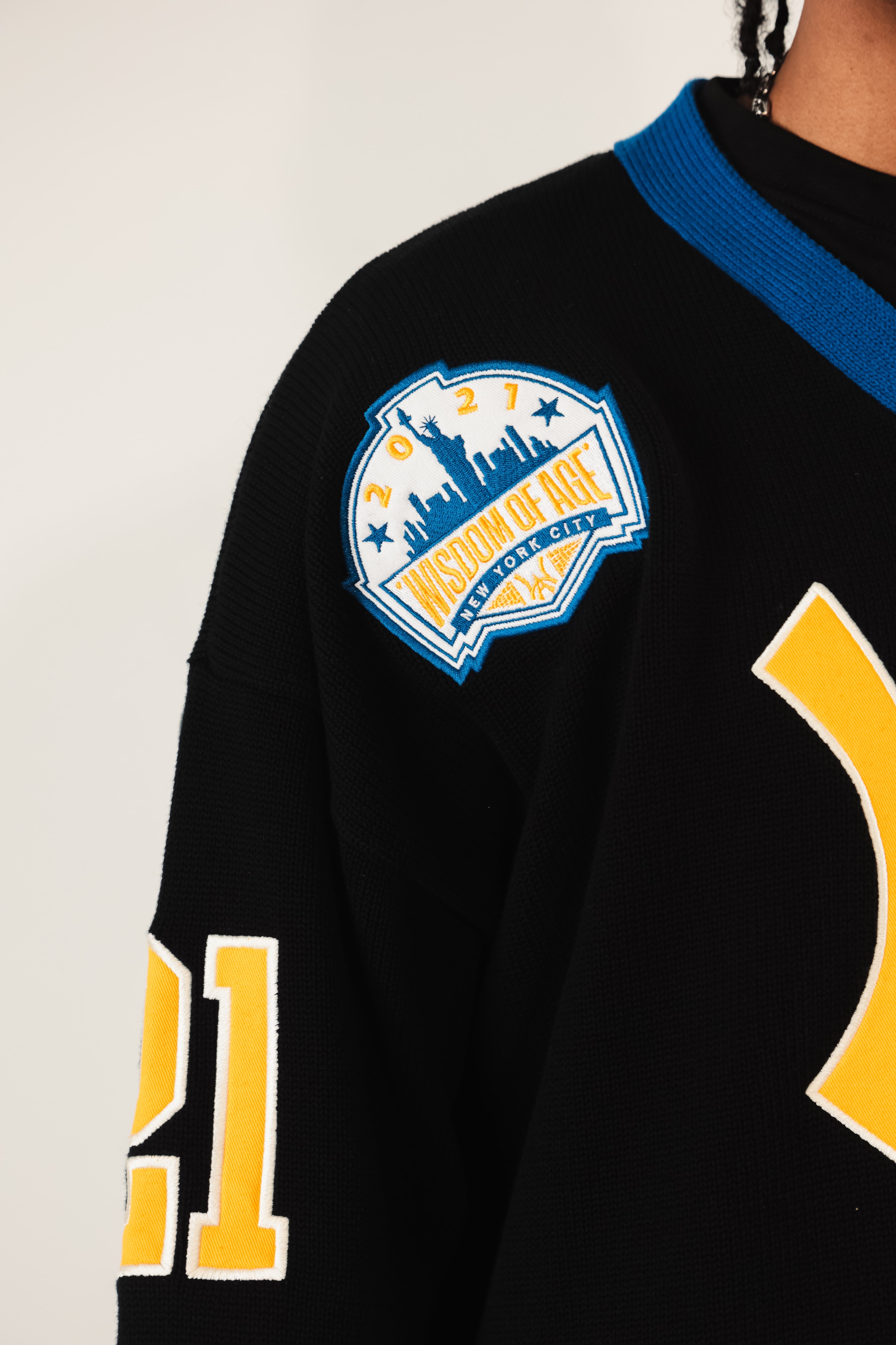 Close up of the Wisdom of Age liberty patch featuring the NYC skyline.