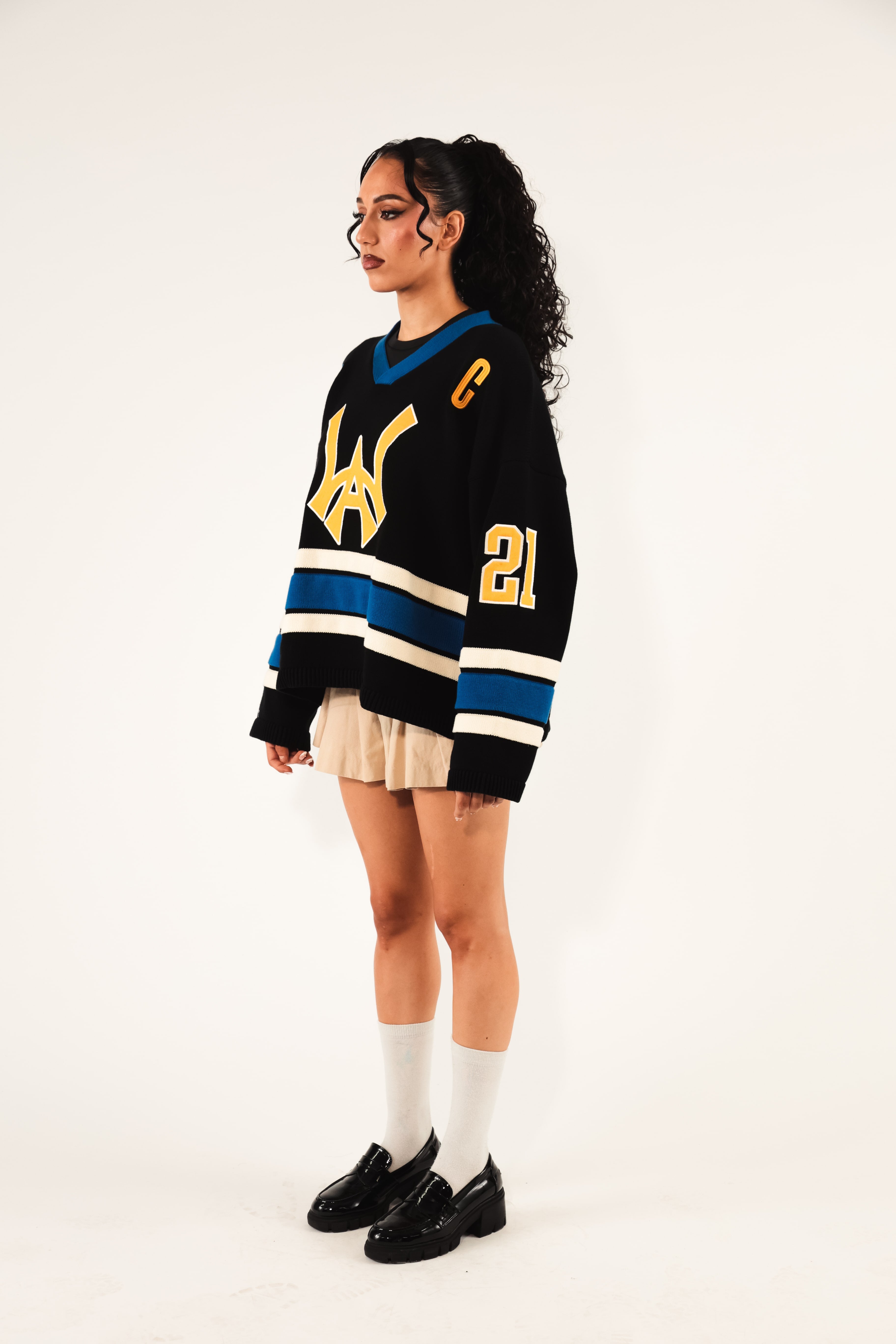 Side View of a Female model Wearing The Wisdom Of Age Hockey Jersey - Static Shock