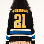 Rear View Of A Female model Wearing The Wisdom Of Age Hockey Jersey - Static Shock. 'Wisdom Of Age' written on the name plate with the number 21.