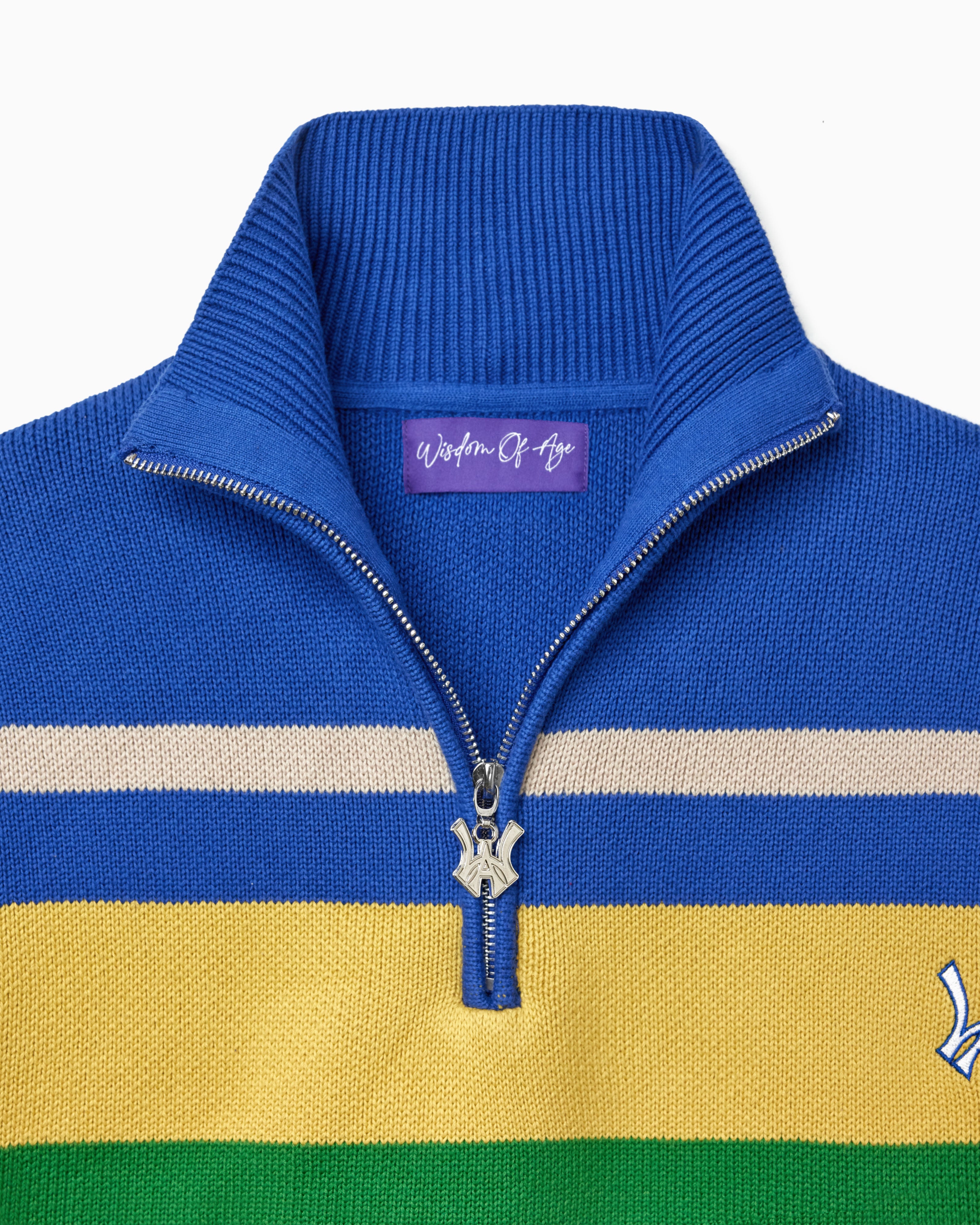 Blue sweater with yellow and green stripes and a visible Wisdom Of Age tag on a white background