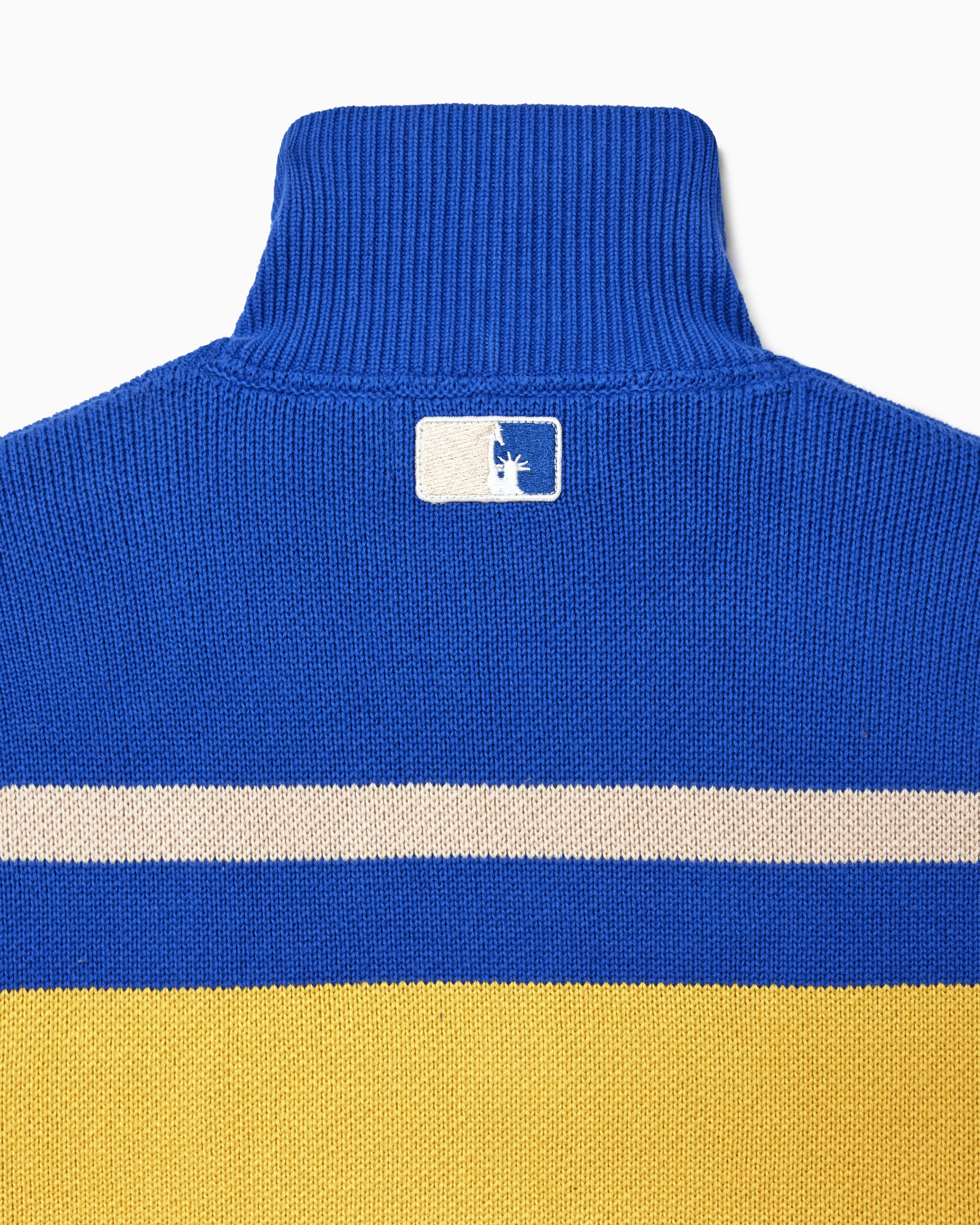 Blue, white, and yellow striped sweater with the NY Tough on a white background
