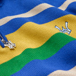 Close-up of a colorful striped sweater with the WA logo on a blue background