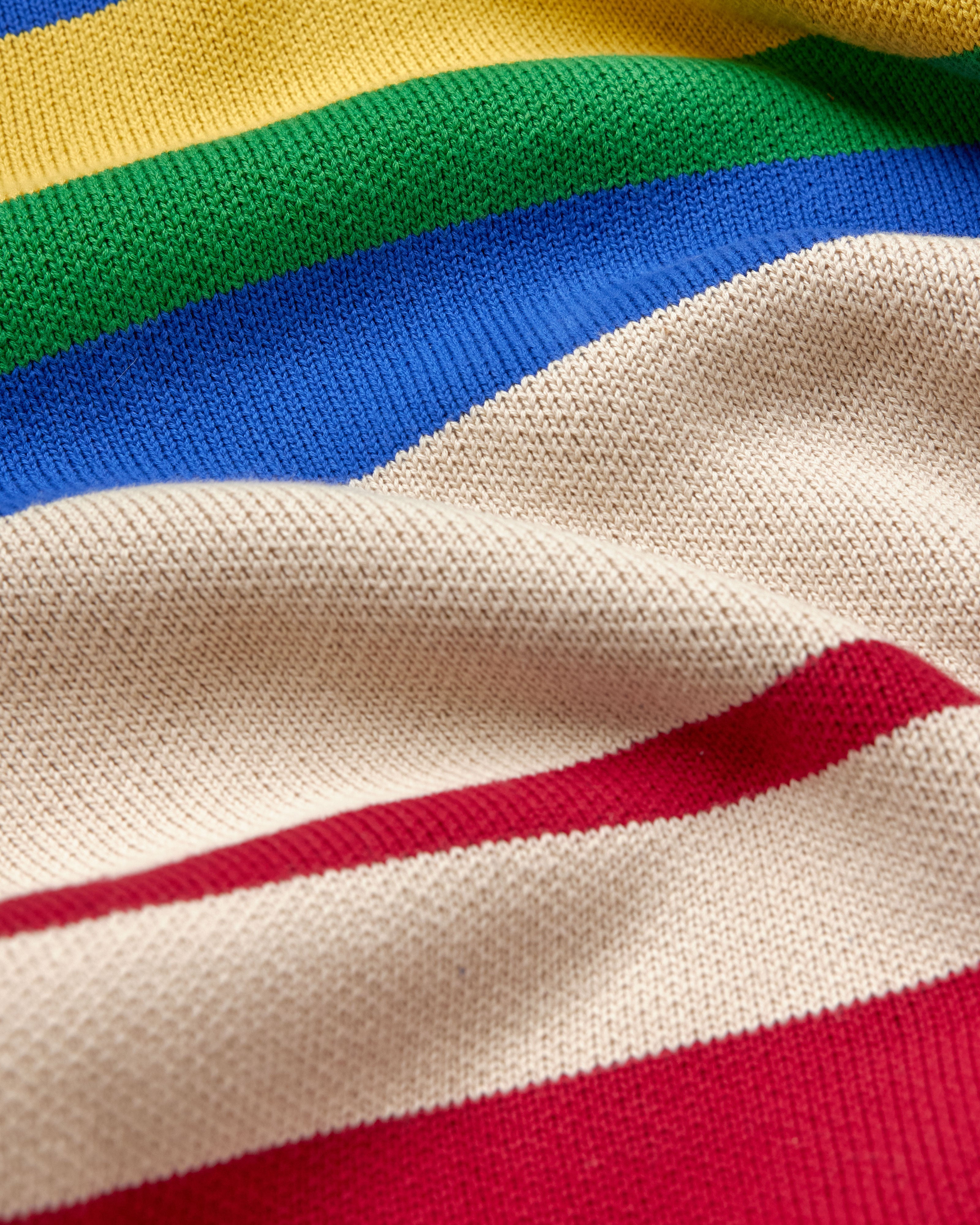 Close-up of a multicolored striped fabric with red, white, blue, green, and yellow.