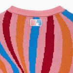 Close-up of a colorful striped sweater with a the NY Tough logo on a white background
