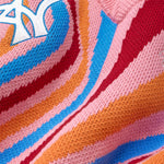 Close-up of a colorful fabric with the WA logo in the upper left