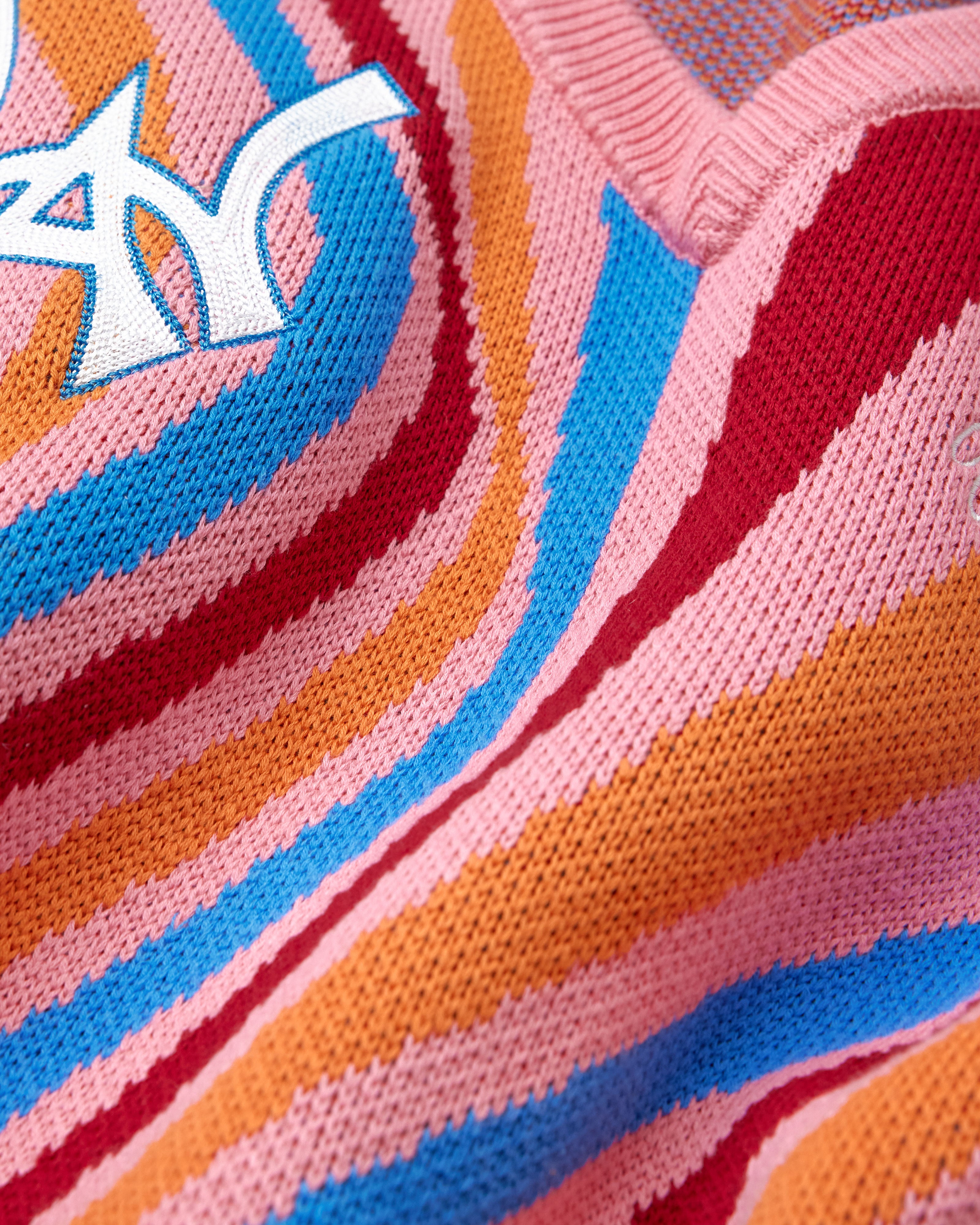 Close-up of a colorful fabric with the WA logo in the upper left