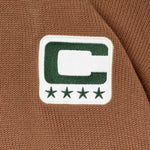 Close-up of a captains patch on a brown fabric background