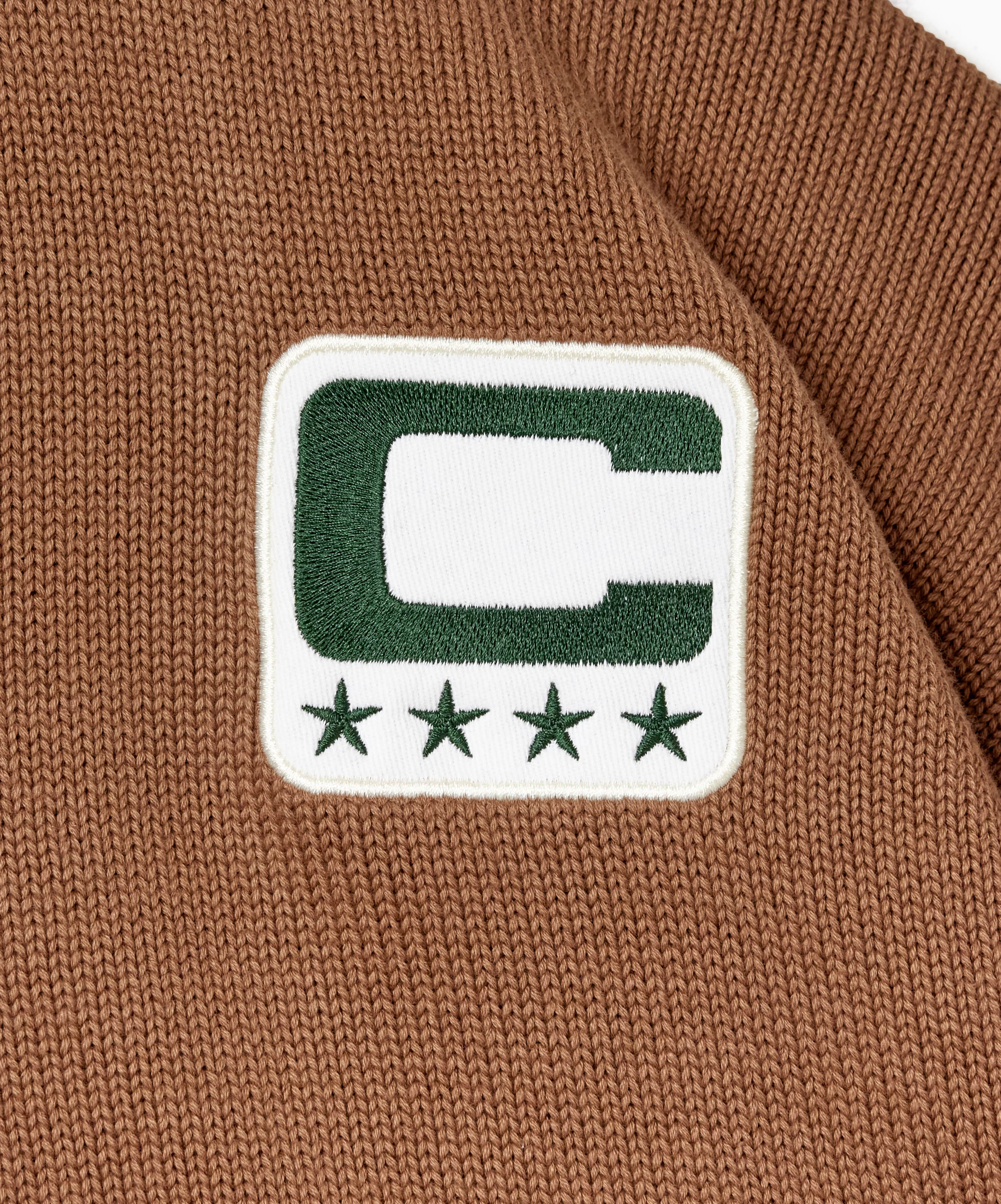 Close-up of a captains patch on a brown fabric background