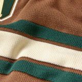 Close-up of a brown sweater with green and white stripes