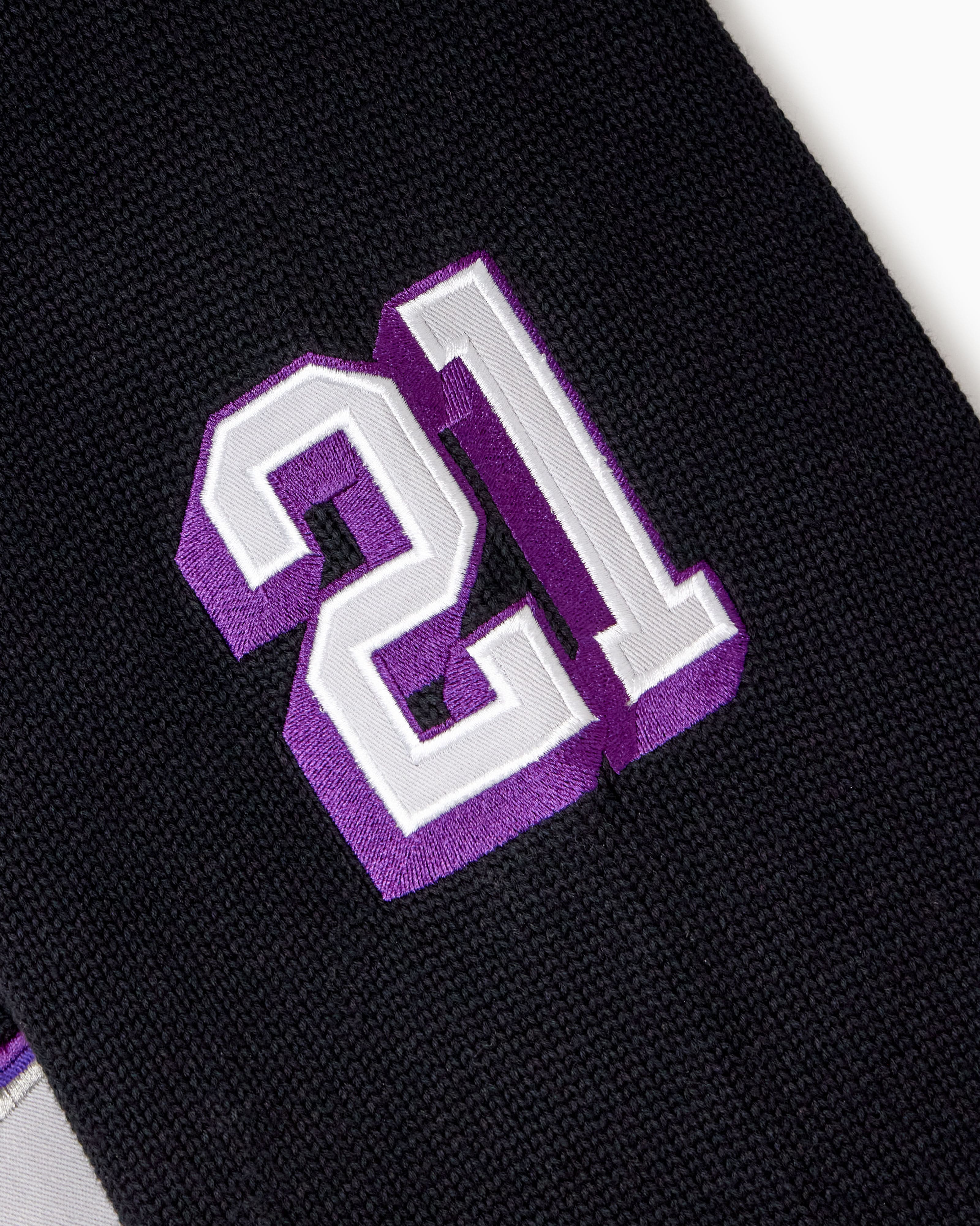 Black sleeve with purple and white number '21' on a white background
