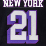 Close up of the back of the WOA Hockey Jersey in Midnight. 'New York' on the name plate and number '21' in white and purple