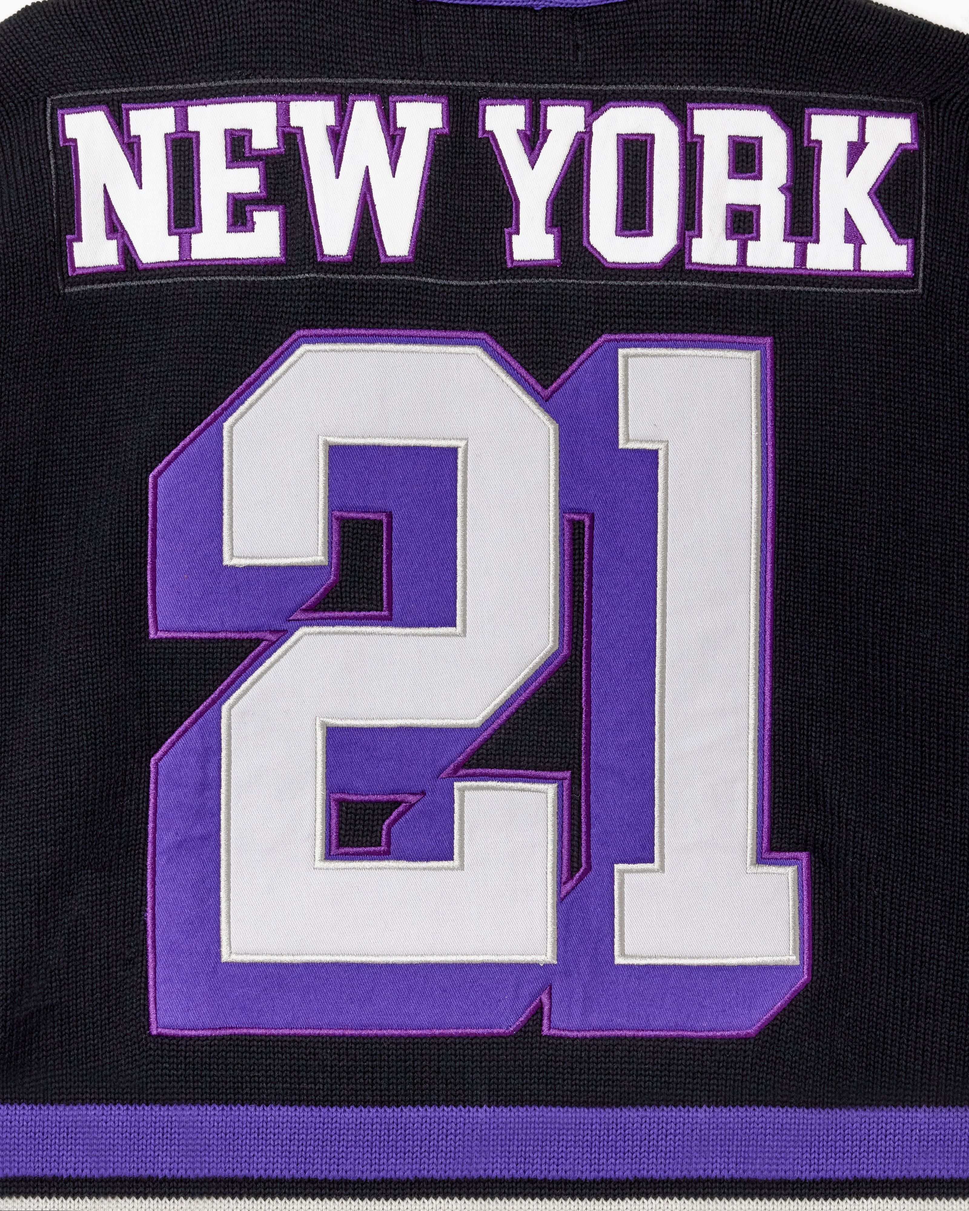 Close up of the back of the WOA Hockey Jersey in Midnight. 'New York' on the name plate and number '21' in white and purple