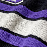 Close-up of a sweater with purple, white, and black stripes