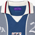Blue and gray knitted soccer jersey with a WOA logo and number 21 on a white background