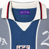 Blue and gray knitted soccer jersey with a WOA logo and number 21 on a white background