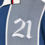 Close-up of a knitted soccer jersey with the number 21 on a blue and gray background