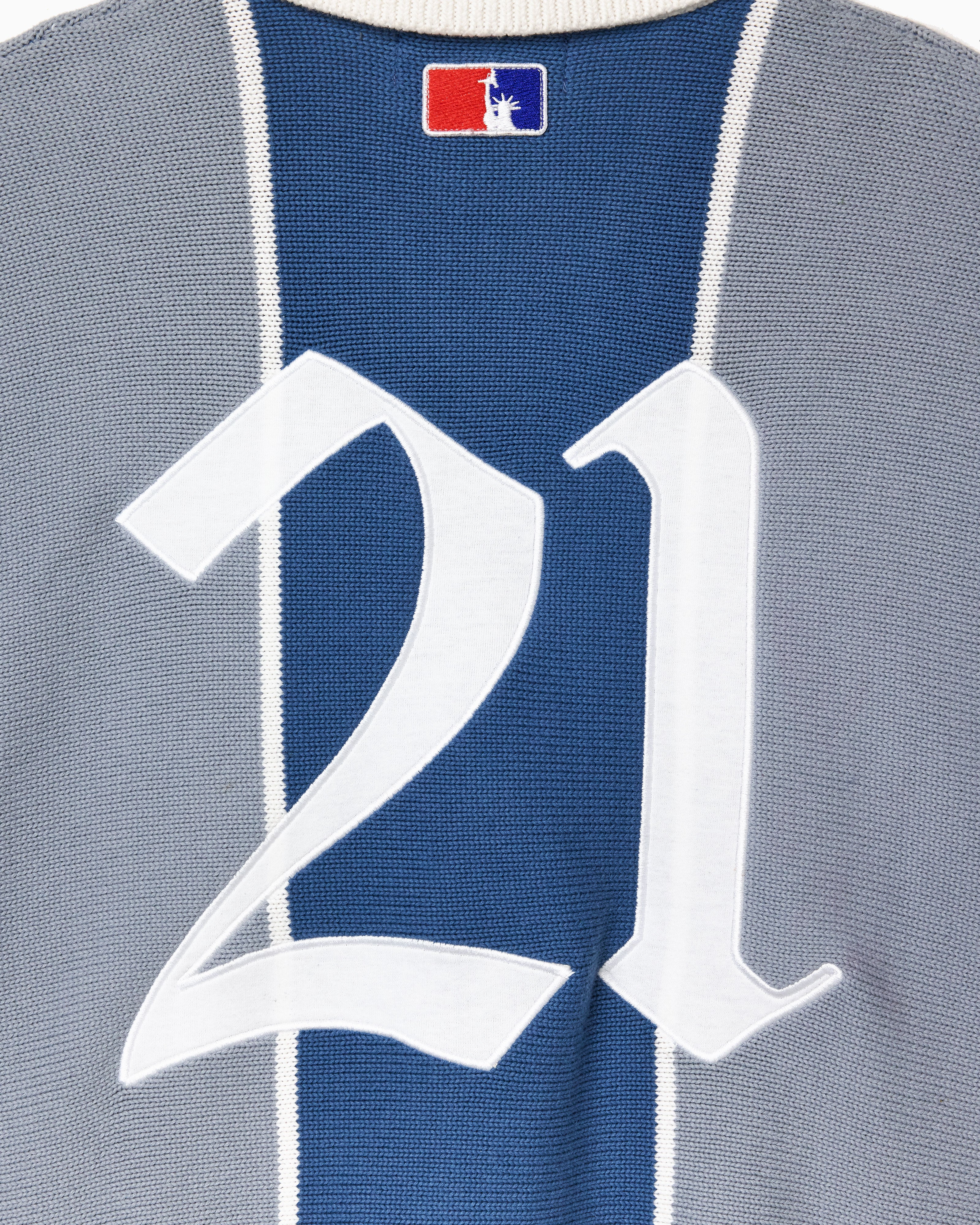 Close-up of a knitted soccer jersey with number 21 and 'NY TOUGH' logo.
