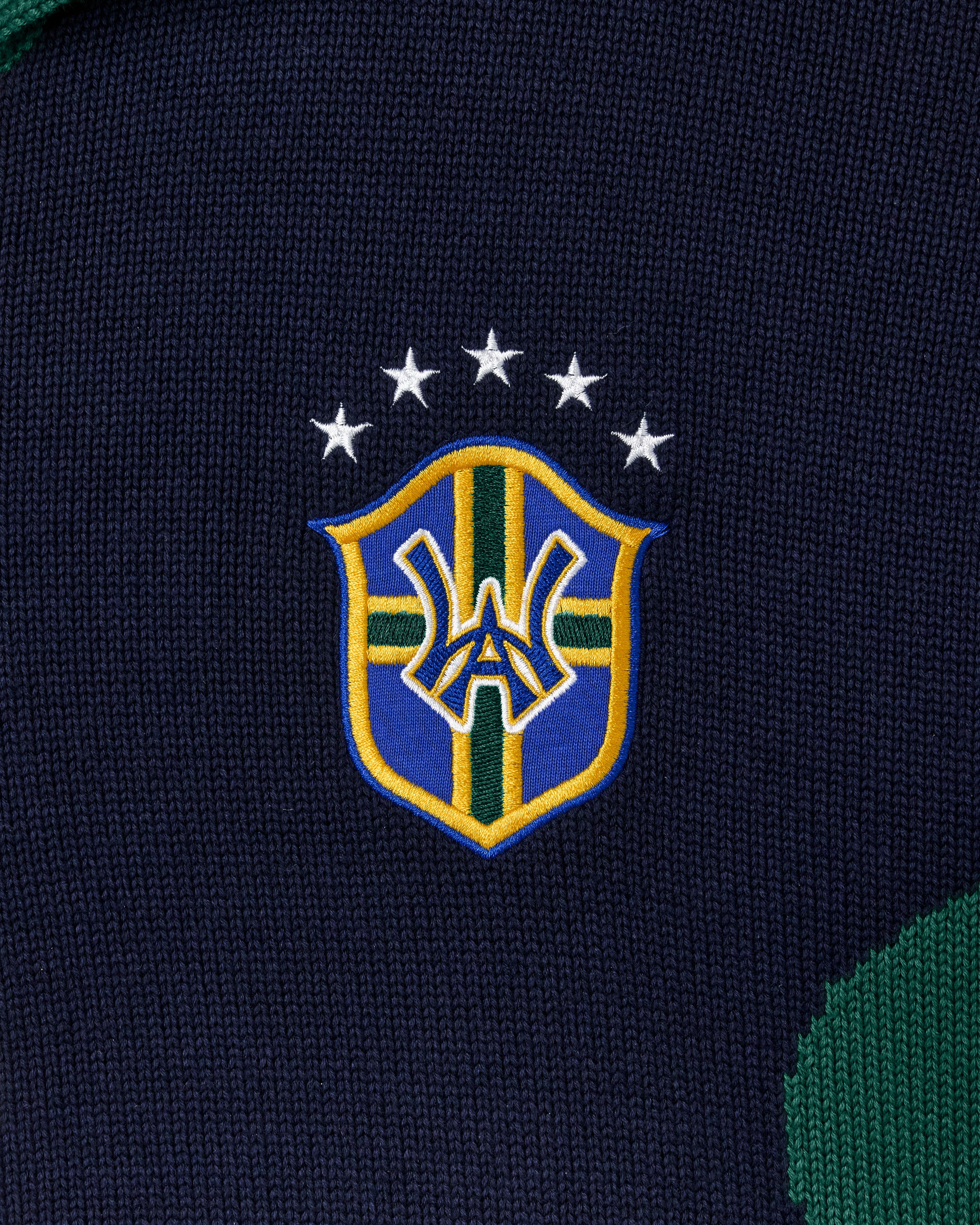 Close-up of a WA crest on a black fabric background
