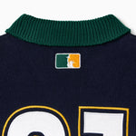Close up of a green collar with the 'NY tough' logo on a white background.
