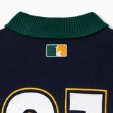 Close up of a green collar with the 'NY tough' logo on a white background.